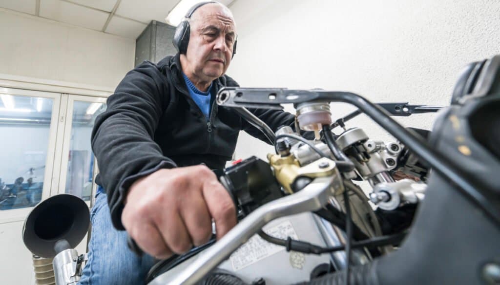 Engineer testing power of a motorcycle on a dynamometer.