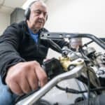 Engineer testing power of a motorcycle on a dynamometer.